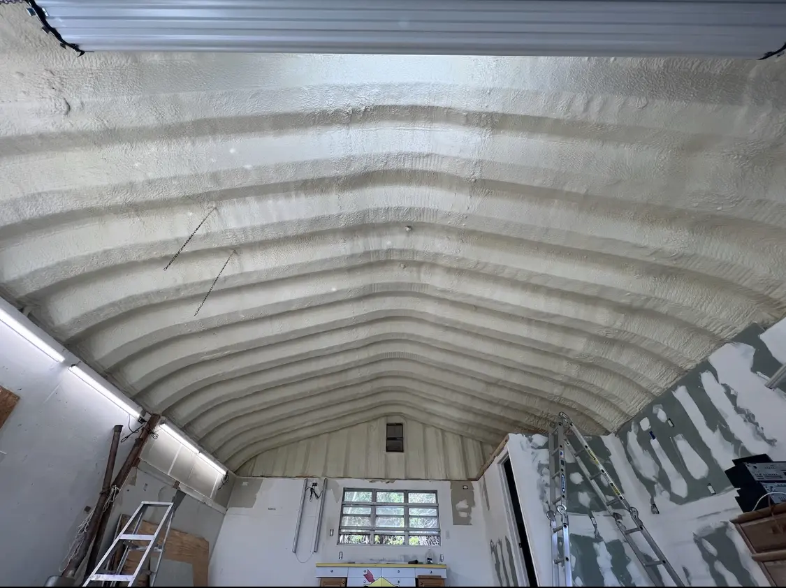 Spray polyurethane foam applied to the underside of a metal roof deck in Madison